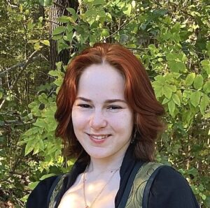 Picture of smiling woman with pale skin and reddish hair